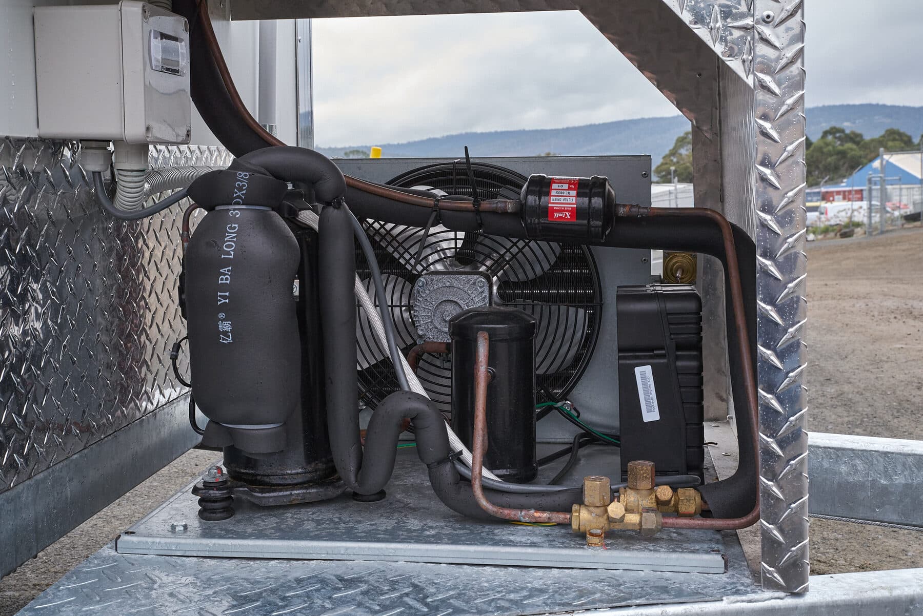 The refrigeration unit mounted on the front of a trailer